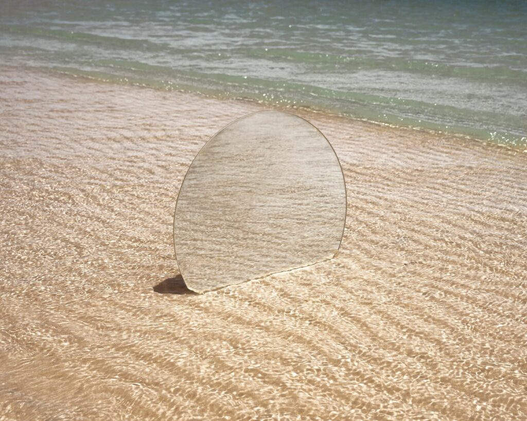 round-glass-mirror-beach-reflecting-landscape_23-2149574151